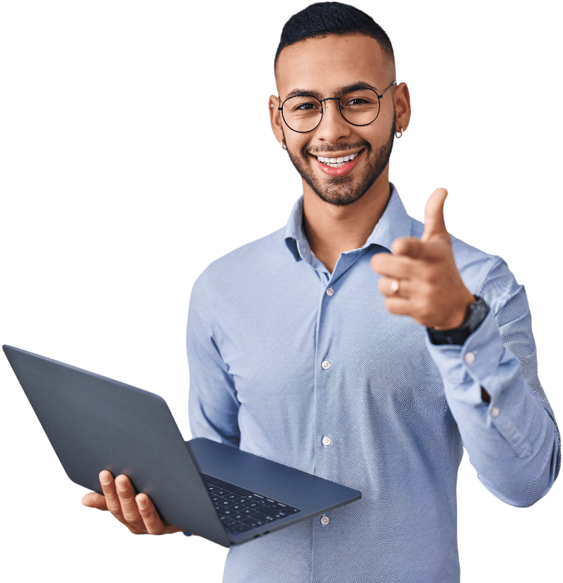 Smiling young man in a blue shirt holds a laptop and gives a thumbs-up, conveying enthusiasm and confidence in a professional setting.